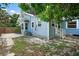 Side view of charming light blue home with a grassy yard at 2111 Burlington N Ave, St Petersburg, FL 33713