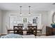 Dining room with a wooden table and chairs, overlooking the kitchen at 10315 Lake Carroll Way, Tampa, FL 33618