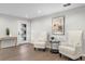 Bright and airy entryway with hardwood floors, two comfy armchairs, and a console table at 10315 Lake Carroll Way, Tampa, FL 33618