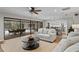 Living room with sliding doors opening to a patio, featuring sofas and a coffee table at 10315 Lake Carroll Way, Tampa, FL 33618