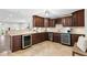 Modern wet bar featuring dark wood cabinets and granite at 10315 Lake Carroll Way, Tampa, FL 33618