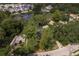 An aerial view of a neighborhood with mature trees, a pond and a mix of single Gathering and townhome style homes at 12318 Woodleigh Ave, Tampa, FL 33612