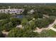 An elevated view of a pond surrounded by homes, buildings and trees at 12318 Woodleigh Ave, Tampa, FL 33612
