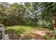 Backyard featuring lush green grass with lake access at 12318 Woodleigh Ave, Tampa, FL 33612