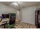 Neutral bedroom showcasing wood-look floors, white closets, and ceiling fan at 12318 Woodleigh Ave, Tampa, FL 33612