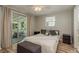 Cozy bedroom with sliding glass doors to porch, letting in natural light and fresh air at 12318 Woodleigh Ave, Tampa, FL 33612