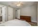 Comfortable bedroom with neutral tones, ceiling fan, closet, and ensuite bathroom access at 12318 Woodleigh Ave, Tampa, FL 33612