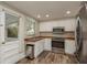 Bright kitchen with white cabinets, stainless steel appliances, and butcher block countertops at 12318 Woodleigh Ave, Tampa, FL 33612