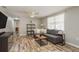 Bright living room with hardwood flooring, gray sofa, ceiling fan, and natural light at 12318 Woodleigh Ave, Tampa, FL 33612