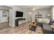 Comfortable living room with wood floors, ceiling fan, and modern furnishings; spacious layout at 12318 Woodleigh Ave, Tampa, FL 33612