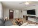Inviting living room featuring a gray sofa, wood floors, and a seamless transition to other rooms at 12318 Woodleigh Ave, Tampa, FL 33612