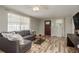 Cozy living room showcasing a gray sofa, modern furnishings, and inviting hardwood floors at 12318 Woodleigh Ave, Tampa, FL 33612