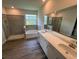 Spacious primary bathroom with dual sinks, tiled shower, separate tub, and sleek fixtures, modern and bright at 4303 Pullet Ct, Lakewood Ranch, FL 34211