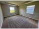 Neutral bedroom featuring a spacious layout, plush carpet, and natural light from two bright, picturesque windows at 4303 Pullet Ct, Lakewood Ranch, FL 34211
