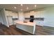 Modern kitchen featuring a large island, sleek countertops, stainless steel appliances, and ample cabinet space at 4303 Pullet Ct, Lakewood Ranch, FL 34211