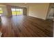Open-concept living room with hardwood floors, large sliding glass doors, and natural light, perfect for entertaining at 4303 Pullet Ct, Lakewood Ranch, FL 34211