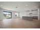 Open-concept living space with tile flooring, recessed lighting, and sliding glass doors to the backyard at 6218 Hidden Branch, Apollo Beach, FL 33572