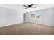 Spacious bedroom with ceiling fan and neutral-toned carpeting at 7111 Moravian Dr, Port Richey, FL 34668