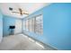 Blue bedroom with window and ceiling fan at 5521 80Th N St # 310, St Petersburg, FL 33709