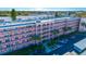 Aerial view of a pink apartment building with ample parking at 5521 80Th N St # 310, St Petersburg, FL 33709