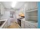 Condo kitchen with white cabinets and appliances at 5521 80Th N St # 310, St Petersburg, FL 33709
