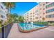 Community pool with surrounding patio and building view at 5521 80Th N St # 310, St Petersburg, FL 33709