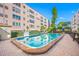 Community swimming pool with brick patio and building view at 5521 80Th N St # 310, St Petersburg, FL 33709