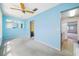 Blue bedroom featuring a ceiling fan and access to other rooms at 5521 80Th N St # 310, St Petersburg, FL 33709