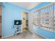 Bedroom with light blue walls, window, and closet at 5521 80Th N St # 310, St Petersburg, FL 33709