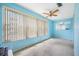 Light blue bedroom with window and ceiling fan at 5521 80Th N St # 310, St Petersburg, FL 33709