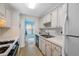 Condo kitchen with white cabinets and appliances at 5521 80Th N St # 310, St Petersburg, FL 33709