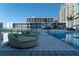 Modern pool deck with comfy lounge chairs and green space at 175 1St S St # 406, St Petersburg, FL 33701