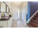 Entryway with white cabinets, wood stairs, and view to the front door at 19501 Sea Myrtle Way, Tampa, FL 33647