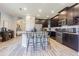 Open concept kitchen with dark cabinets, granite island, and stainless steel appliances at 19501 Sea Myrtle Way, Tampa, FL 33647