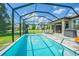 Inviting screened pool with patio furniture and lake view at 19501 Sea Myrtle Way, Tampa, FL 33647