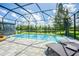 Screened pool with lake view and lounge chairs at 19501 Sea Myrtle Way, Tampa, FL 33647