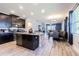 Open kitchen with island, dark cabinets, granite countertops, and view of the dining and living areas at 19501 Sea Myrtle Way, Tampa, FL 33647
