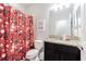 Main bathroom with granite countertop, dark brown vanity, and decorative shower curtain at 19501 Sea Myrtle Way, Tampa, FL 33647