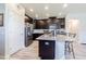 Kitchen with dark cabinets, granite counters, island with seating, and stainless steel appliances at 19501 Sea Myrtle Way, Tampa, FL 33647