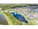Aerial view of neighborhood with lake and houses at 19501 Sea Myrtle Way, Tampa, FL 33647