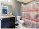 Clean bathroom with granite countertop, dark vanity, and striped shower curtain at 19501 Sea Myrtle Way, Tampa, FL 33647