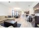 Open living room features a large sectional sofa, hardwood floors, and views into the kitchen at 19501 Sea Myrtle Way, Tampa, FL 33647
