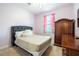 Serene bedroom with a queen bed, wooden armoire, and soft color palette at 19501 Sea Myrtle Way, Tampa, FL 33647