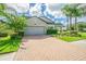 Two-story house with gray garage door and brick driveway at 19501 Sea Myrtle Way, Tampa, FL 33647