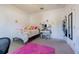 Bright bedroom with a full-size bed, pink rug, and stylish decor at 19501 Sea Myrtle Way, Tampa, FL 33647
