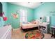 Quaint bedroom with a twin-size bed, colorful rug, and a vanity at 19501 Sea Myrtle Way, Tampa, FL 33647