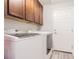 Laundry room with wood cabinets, washer, and dryer at 19501 Sea Myrtle Way, Tampa, FL 33647