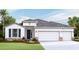 Two-story house with white siding, double garage, and landscaping at 4303 Pullet Ct, Lakewood Ranch, FL 34211
