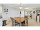 Condo dining area with table and chairs, view of kitchen and living room at 10355 Paradise Blvd # 702, Treasure Island, FL 33706