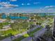 Wide aerial view of the neighborhood and waterfront at 10355 Paradise Blvd # 702, Treasure Island, FL 33706